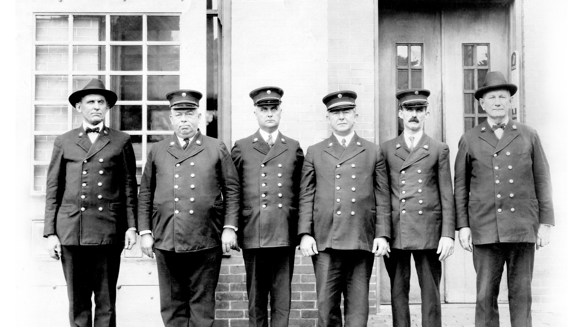 Firefighters lined up in front of fire station