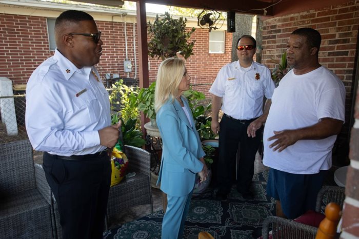 Fire Chief Percy Golden II, Mayor Deegan, Division Chief of Fire Prevention Allen Mason, speak to resident about fire safety