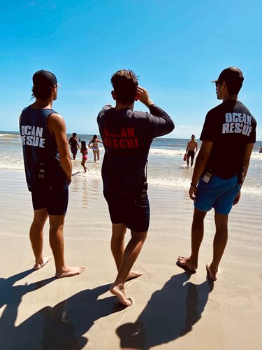 Image of lifeguards looking at the ocean