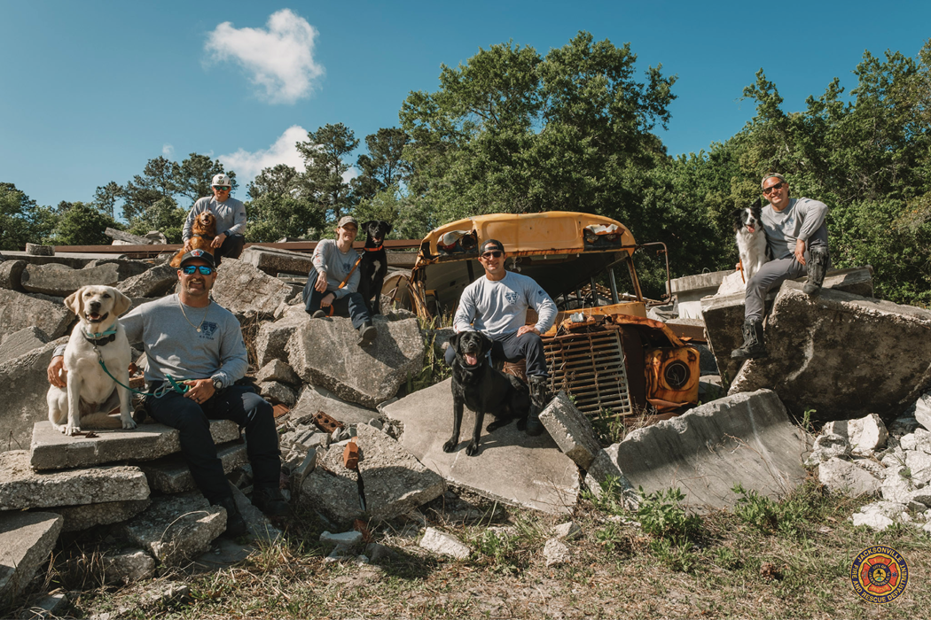 Photo of canines and handlers after the test